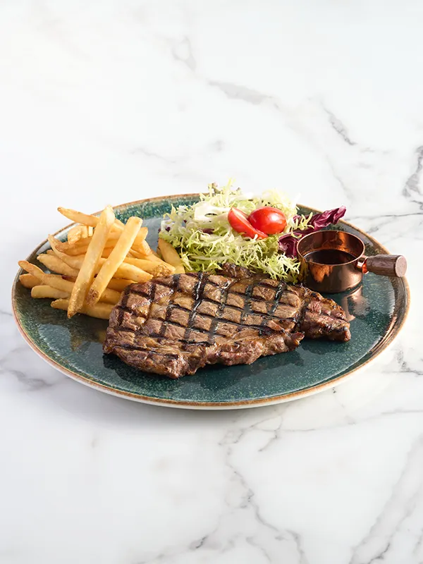 Grilled U.S. Rib Eye Steak with Crispy Fries and Green Salad